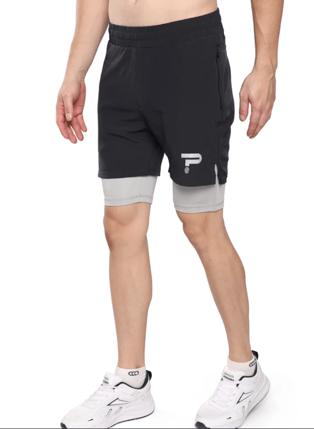Black running shorts worn over a grey compression liner